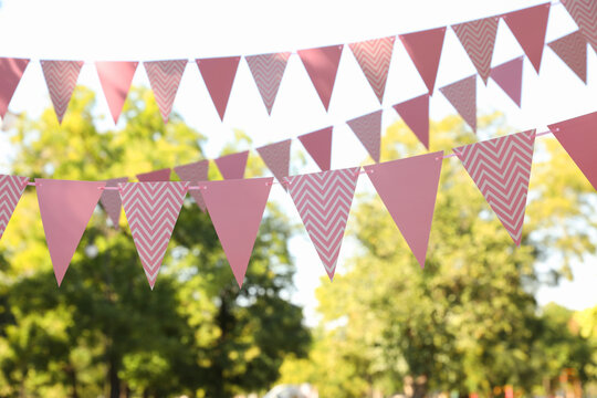 Pink bunting flags in park. Party decor