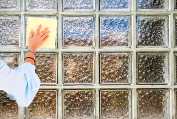 woman hand cleaning glass bricks