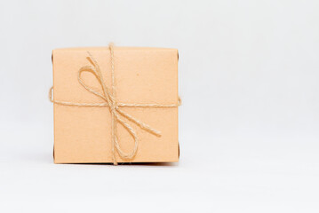 Holiday card. Beige gift box on white background. Flat lay,copy space.