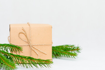 Fototapeta na wymiar Holiday card. Beige gift box on white background. Flat lay,copy space.