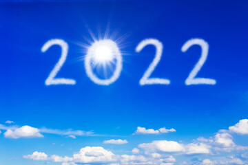 Happy New Year concept. The sun and number 2022 written on blue sky, symbol for a bright future, freedom and normalcy.