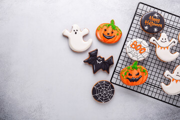 Halloween gingerbread cookies on baking rack on stone background. Bright homemade cookies for...