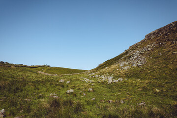 Fototapeta na wymiar Northumberland UK: 07-31-2020 a sunny summer day in English countryside cliffs near the Roman Wall