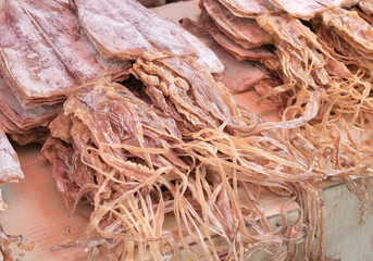 Many dried squid are sold in the market. Seafood image.