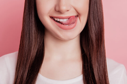 Cropped close-up view portrait of nice attractive lovely cheerful woman lick lips tongue yummy isolated over pink color background