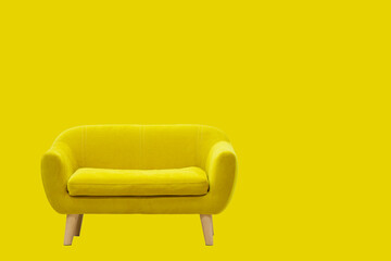 Yellow sofa on wooden legs on a yellow background.