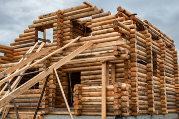 a wooden house under construction a log house consisting of two floors