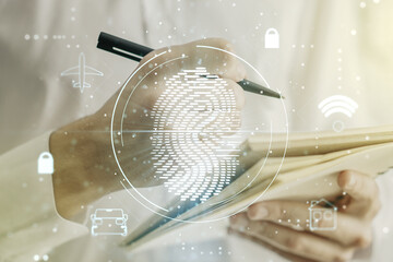 Multi exposure of abstract fingerprint scan interface with man hand writing in notepad on background, digital access concept