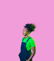 Studio portrait young black woman looking over positive and contemplative daydreaming isolated advertising copyspace background