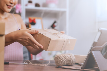 A young girl is packing and selling online.