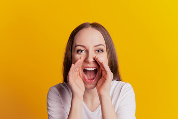 Photo of young girl hand near mouth cool advert yell tell news announcement isolated over yellow color background