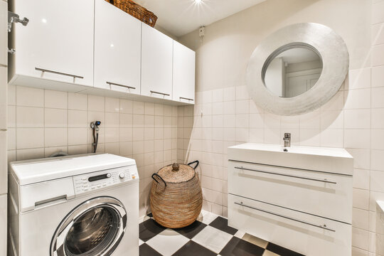 Modern bathroom interior with washbasin under mirror