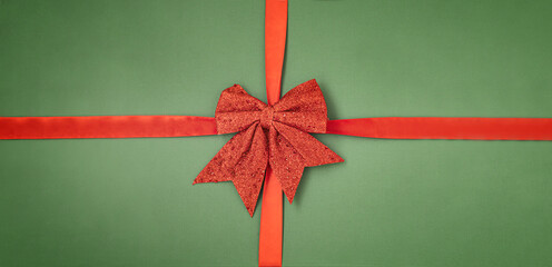 Christmas background with red bow on green