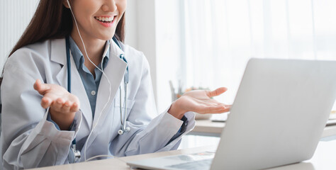 Asian therapist woman doctor is online visiting with a patient on the internet application. Her Listening and Give advice and explains how to treat the initial disease, Concept of Medical technology.