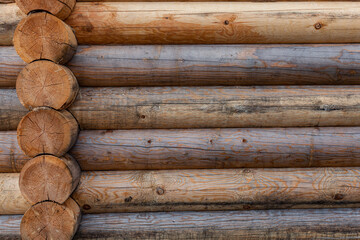 fragment of the wall of a wooden log house