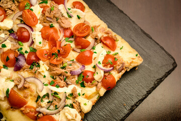 top view of a Big squared pizza slice on a plate ready to be served - obrazy, fototapety, plakaty