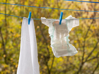 Baby diapers hanging on a clothesline