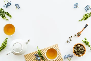 Rolgordijnen Tea drinking with white teapot and black tea in two cups © 9dreamstudio