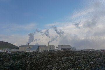 Grindavik, Iceland: Behind a field of lava rocks, the Svartsengi power plant (1976) was the world&acute;s first geothermal source for electric power generation and hot water production.