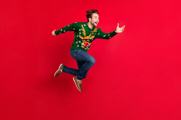 Full size photo of cheerful smiling guy running fast speed in air look copyspace isolated on vivid red color background