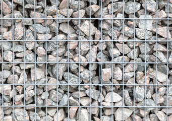 Stones in a metal grid as an abstract background.