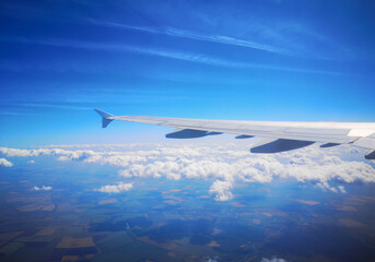 Airplane wing in sky in flight.