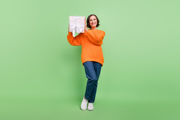Full length photo of attractive senior woman receive gift box shake birthday isolated over green color background