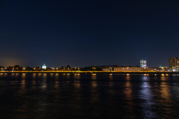 colorful night view of the city embankment across the river