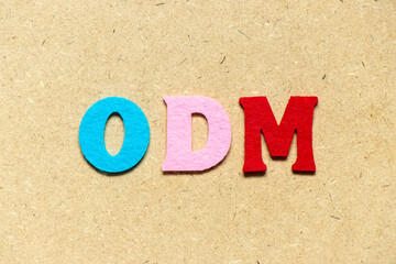 Color cloth alphabet letter in word ODM (Abbreviation of Original design manufacturer) on wood...
