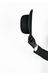 Isolated Image of Man's Arm Holding and Doffing Bowler Hat in Polite Greeting. Copy Space for...
