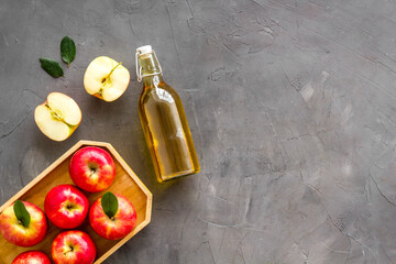 Bottle of organic apple cider vinegar with red apples