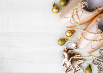 Christmas flat lay pair of pink Pointe Shoes, christmas tree, golden balls, gold star, pearl beads...