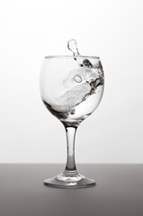 Wineglass with white wine with splash