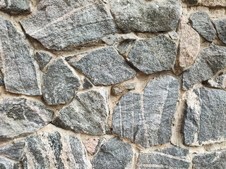 Rough texture old granite stone wall