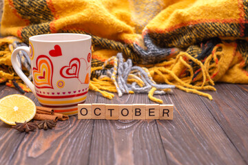Autumn fall flat lay, top view. Autumn leaves, a mug of tea. with the inscription hello autumn on a rustic wooden background