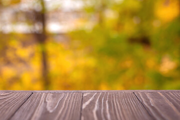 Naklejka na ściany i meble Empty wooden table with abstract yellow bokeh background. For demonstration or installation of your products.