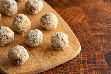 Group of Coconut Chocolate Energy Balls on a Wooden Butcher Block
