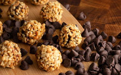 Group of Chocolate Peanut Butter Energy Balls on a Wooden Butcher Block