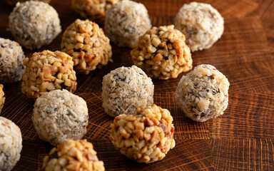 Group of Peanut Butter and Coconut Chocolate Energy Balls on a Wooden Butcher Block