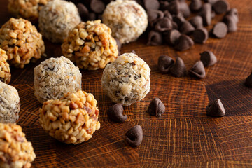 Group of Peanut Butter and Coconut Chocolate Energy Balls on a Wooden Butcher Block