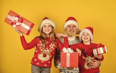 Merry Christmas. new year shopping. time for presents. happy family celebrate xmas. small girls exchange gifts with father. dad love daughters. bearded santa man with kids. knitted fashion for winter