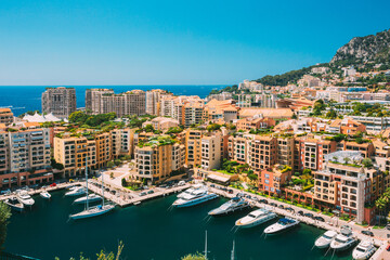 Fototapeta na wymiar Yachts moored near city Pier, Jetty In Sunny Summer Day. Monaco, Monte Carlo