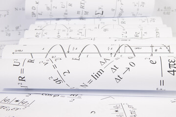 Fototapeta na wymiar printed on paper mathematical electrical formulas, graphs and engineering drawings