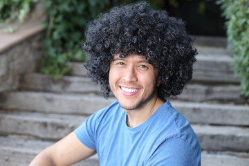 Young Hispanic man with curly hair