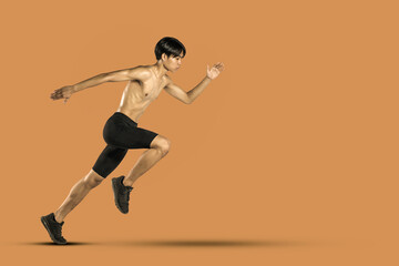 Fototapeta na wymiar Male runner jogging Isolated. On orange background.