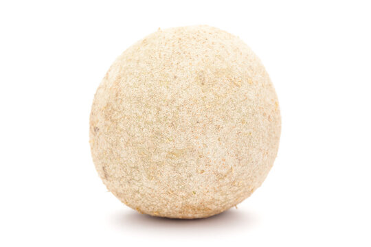 Detailed closeup of one fresh medicinal citrus  fruit of Kavath fruit  (Limonia acidissima), isolated over white background