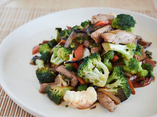 close-up view of an oriental-style stir-fry with broccoli, prawns and meat