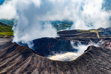 Close up on crater of Aso volcano with clouds and smoke in Kyushu, Japan - obrazy, fototapety, plakaty