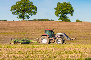 Tractor with cultivator in the field - 9047