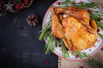Baked  chicken or turkey. The Christmas table is served with turkey, decorated with bright tinsel. Fried chicken, table. Christmas dinner. Table setting. Top view, above